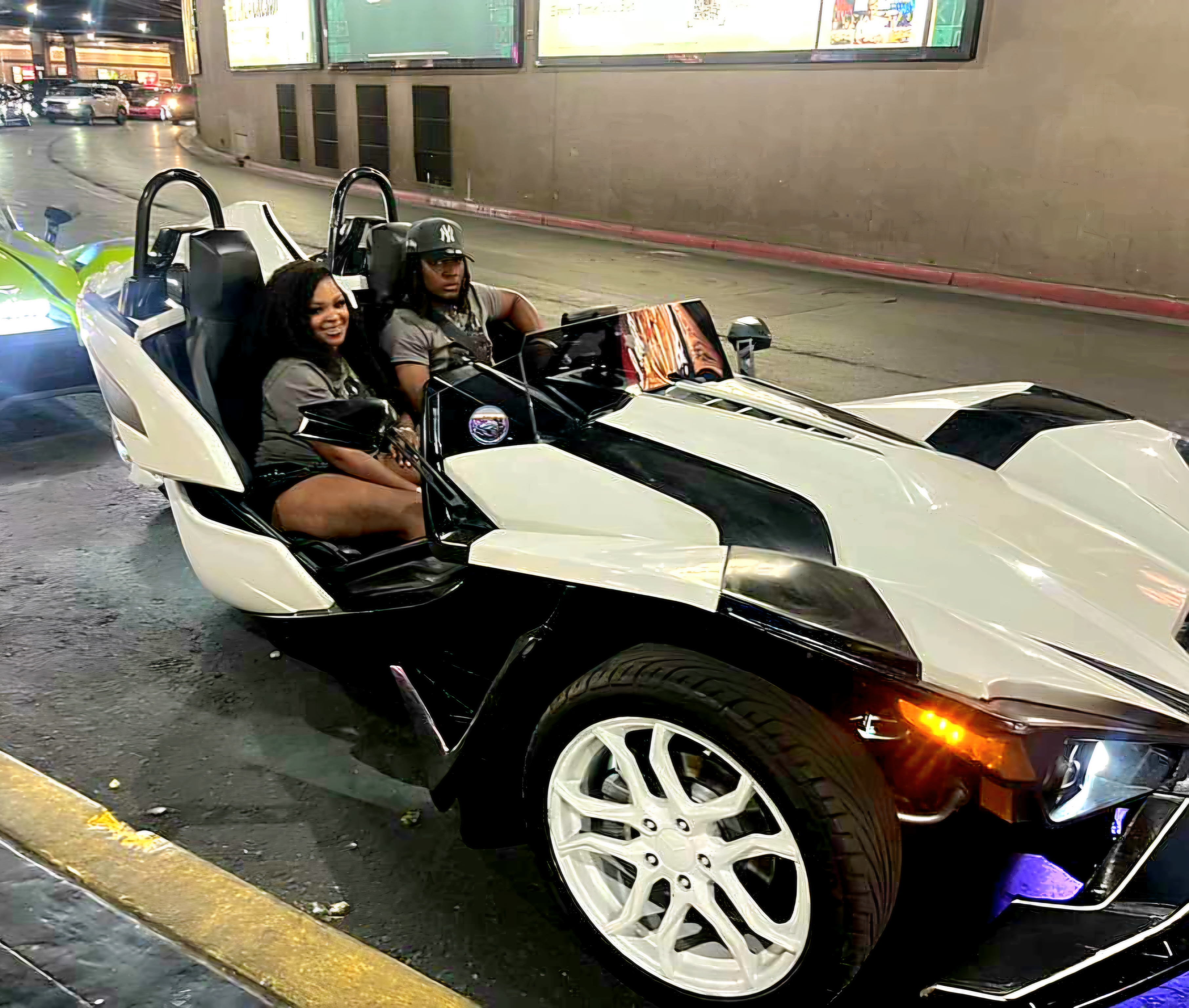 Couple in white Slingshot at night Las Vegas
