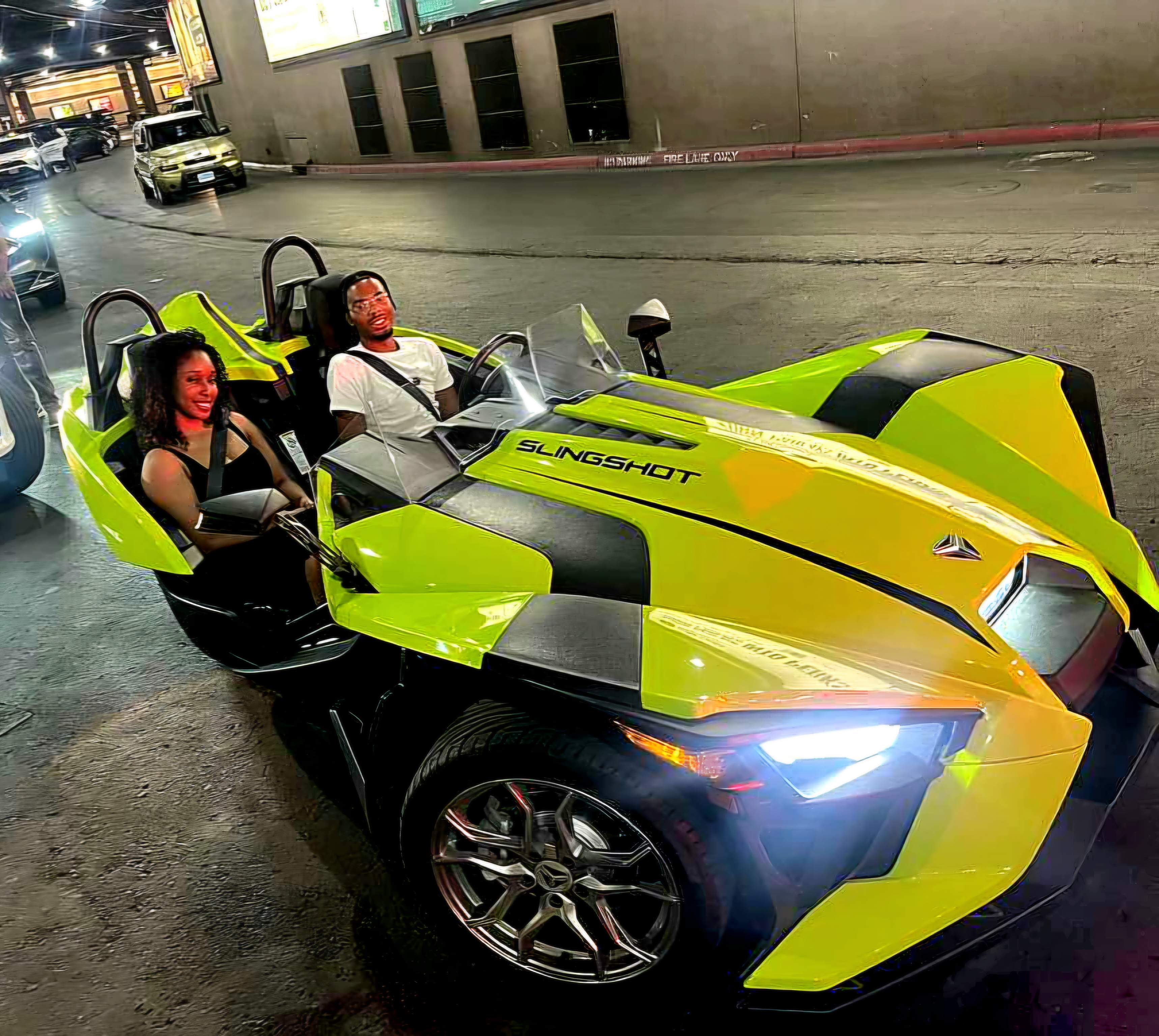 Couple in green Slingshot at night Las Vegas