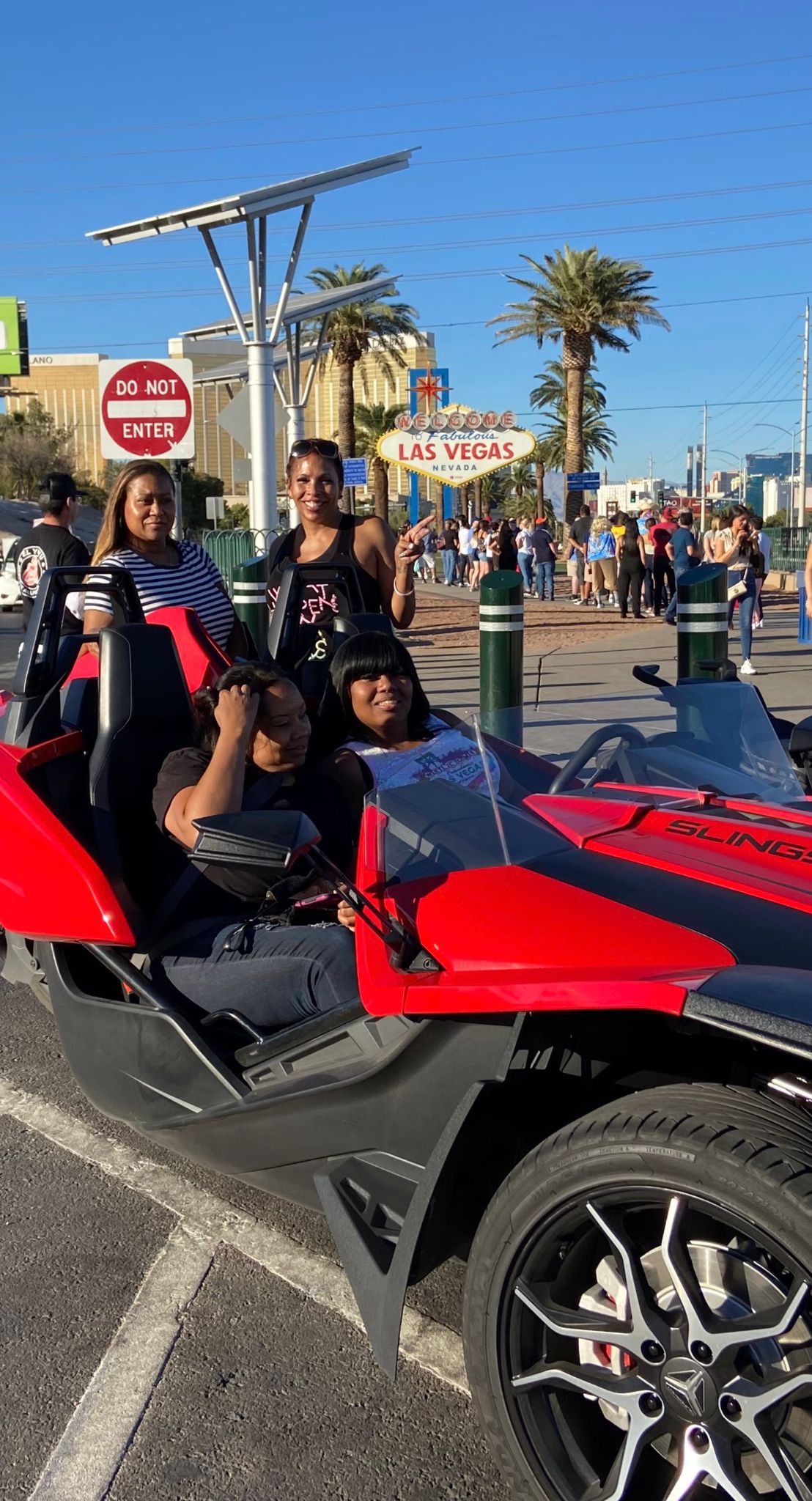 Group in red Slingshot at Welcome to Las Vegas sign