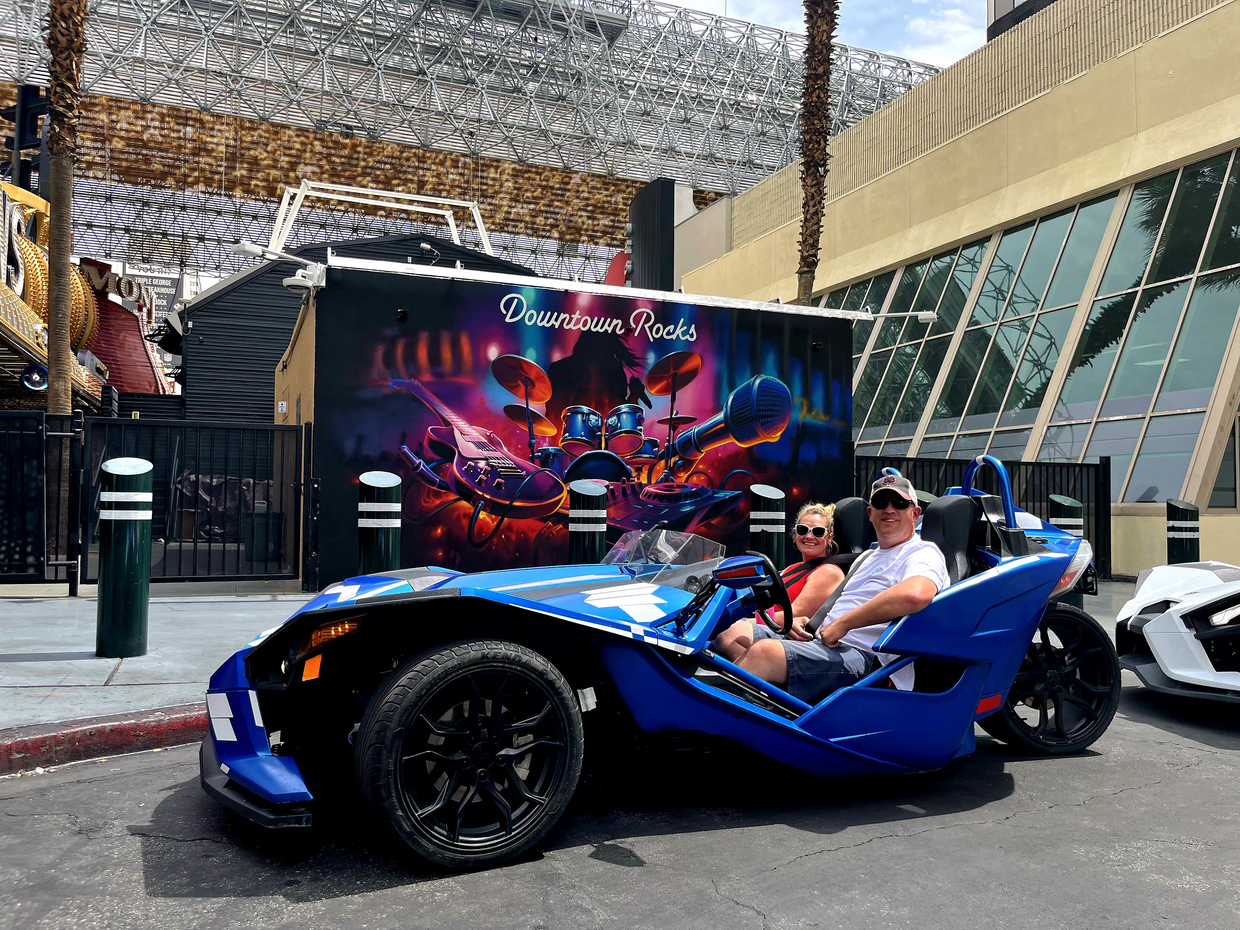 Couple in blue Slingshot at Downtown Rocks Fremont Street