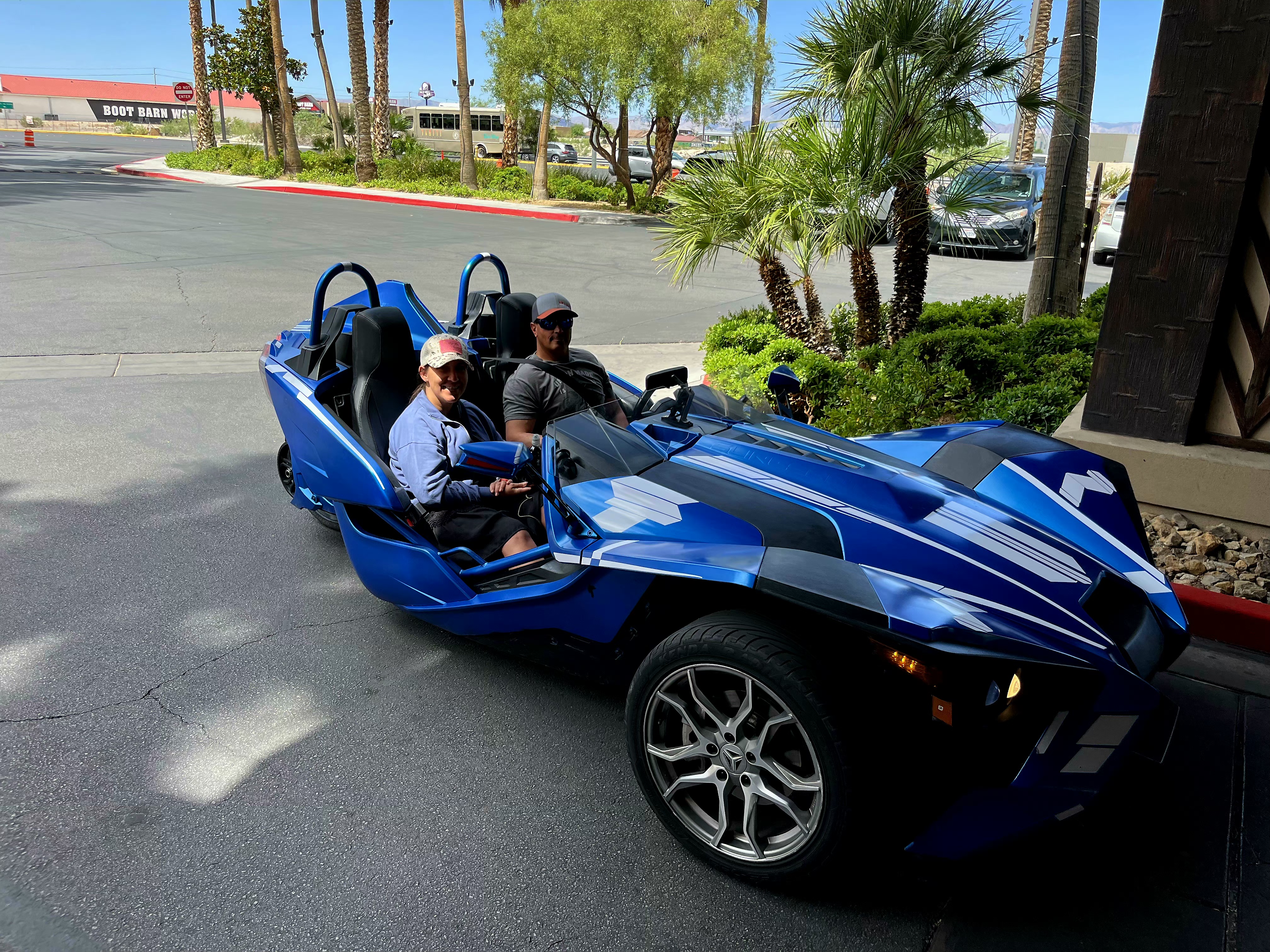 Couple in blue Slingshot near Boot Barn Las Vegas