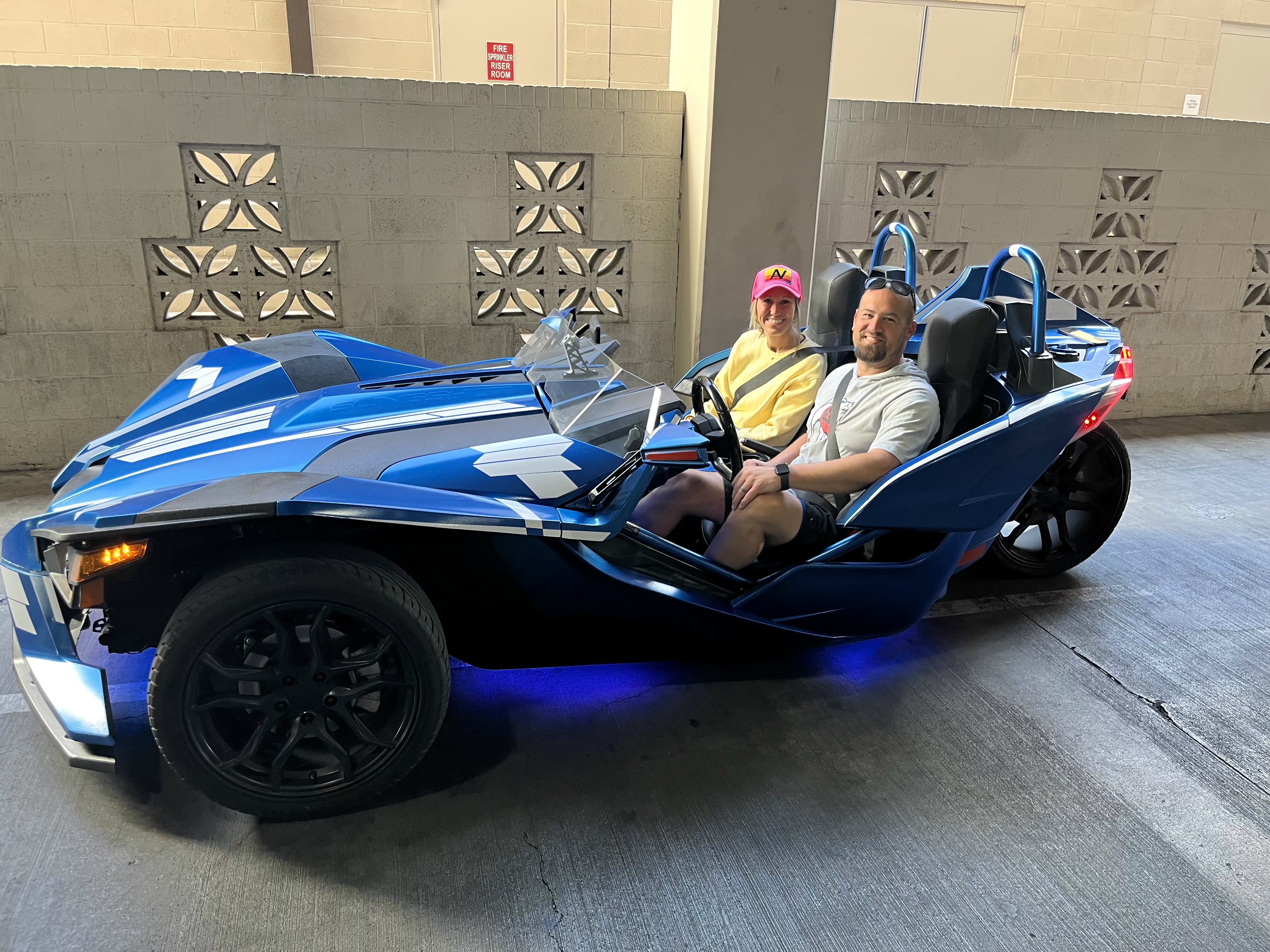 Two men in blue Slingshot at Fremont Street