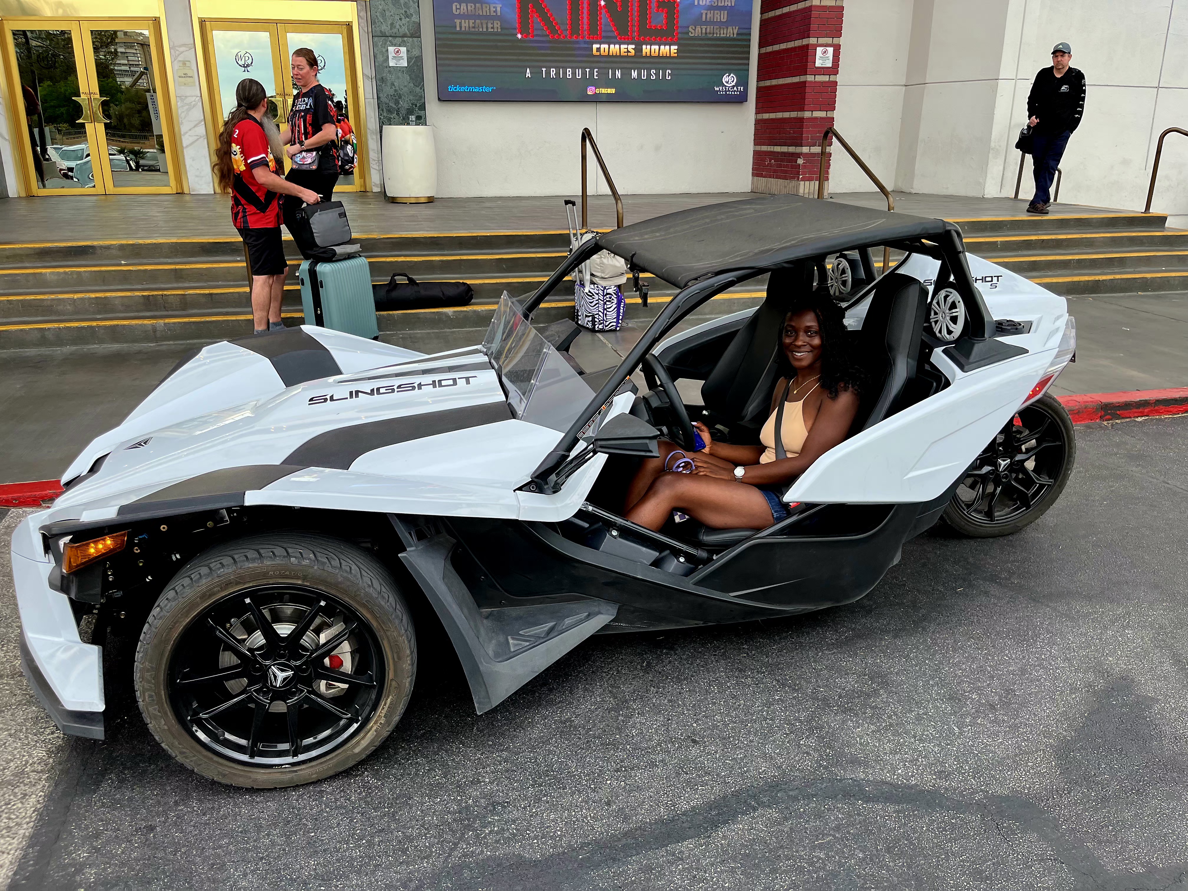 Couple in blue Slingshot at night Las Vegas Strip