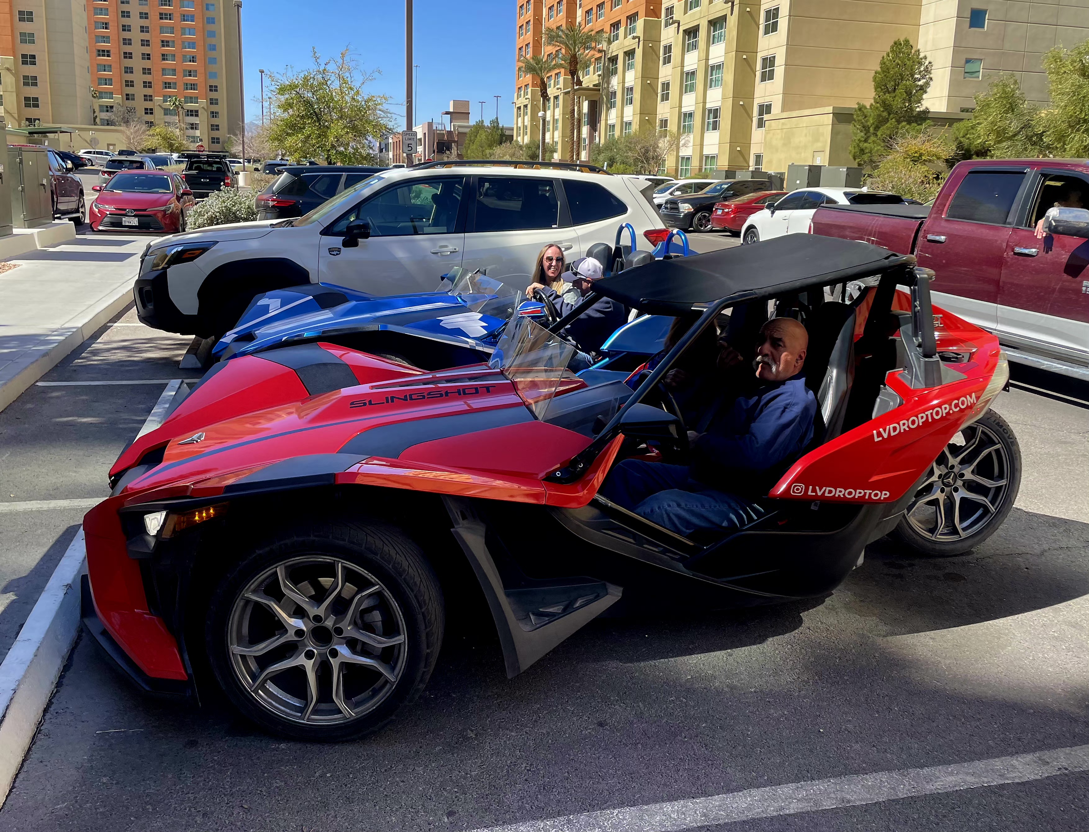 Couple in blue Slingshot parking lot